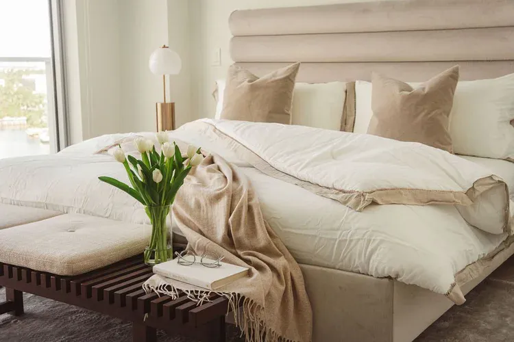 Layered textile bedroom with custom headboard at Flamingo Point residence, Miami Beach
