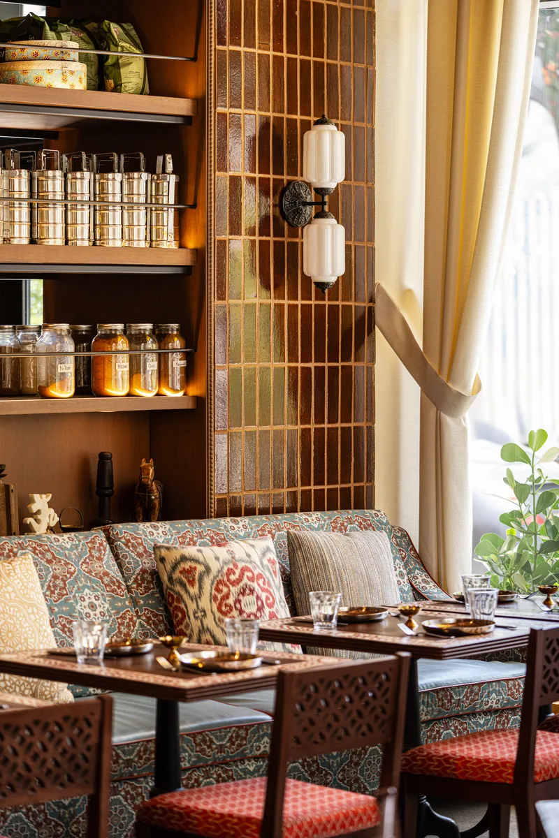 Custom banquette seating with Indian textiles at Ghee restaurant, Wynwood Miami