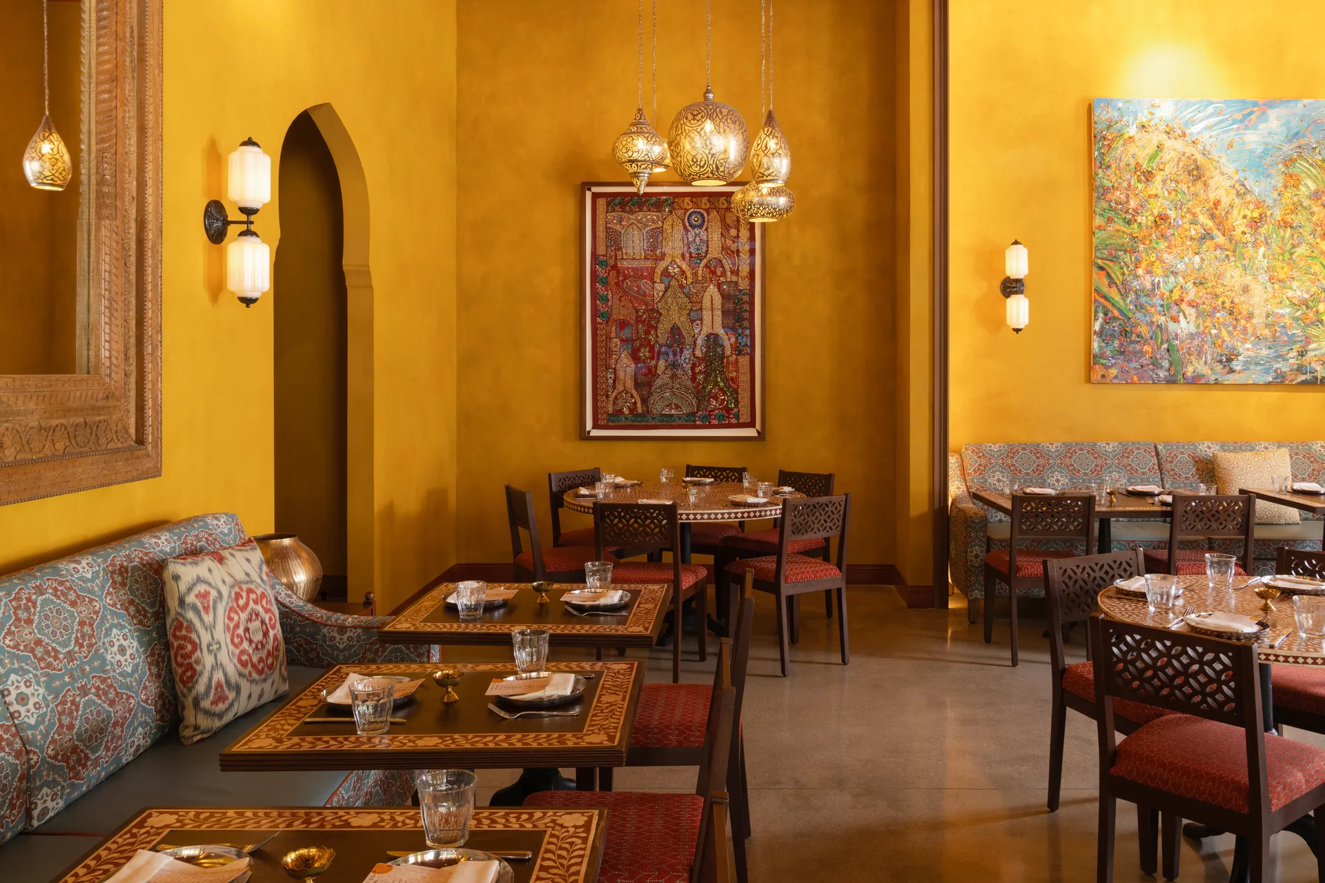 Ghee Indian Kitchen dining room with custom imported furniture and warm textiles, Wynwood Miami