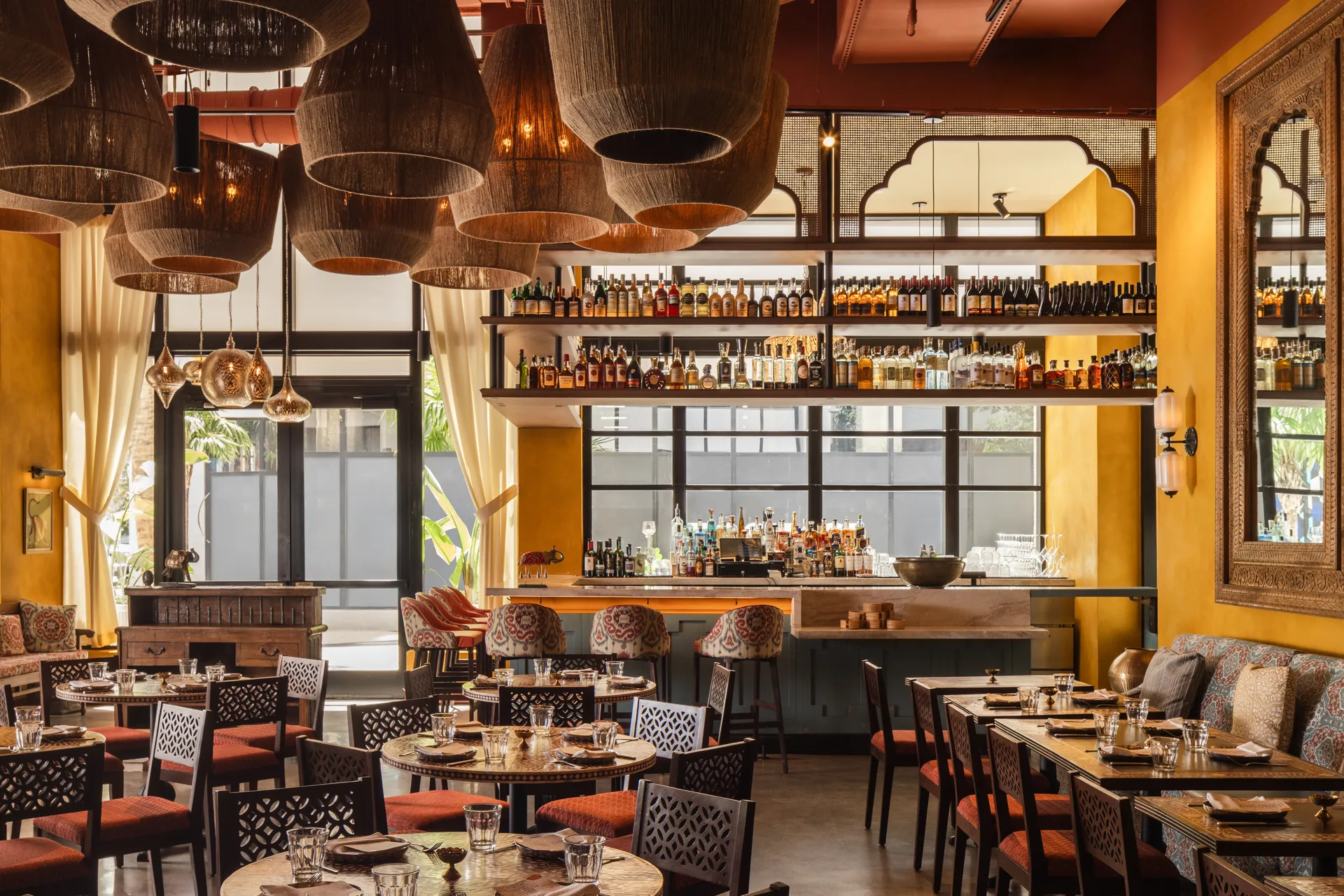 Dining area with carved wood screens and lantern lighting at Ghee Indian Kitchen, Wynwood