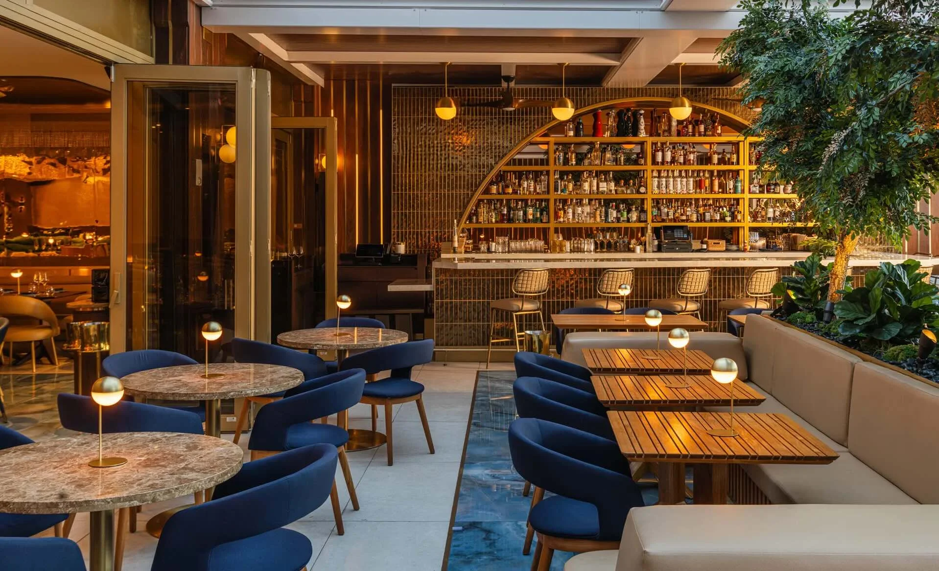 Gold ceiling and brass fixtures at Oro steakhouse, Miami Beach interior design by Hybrid Creative