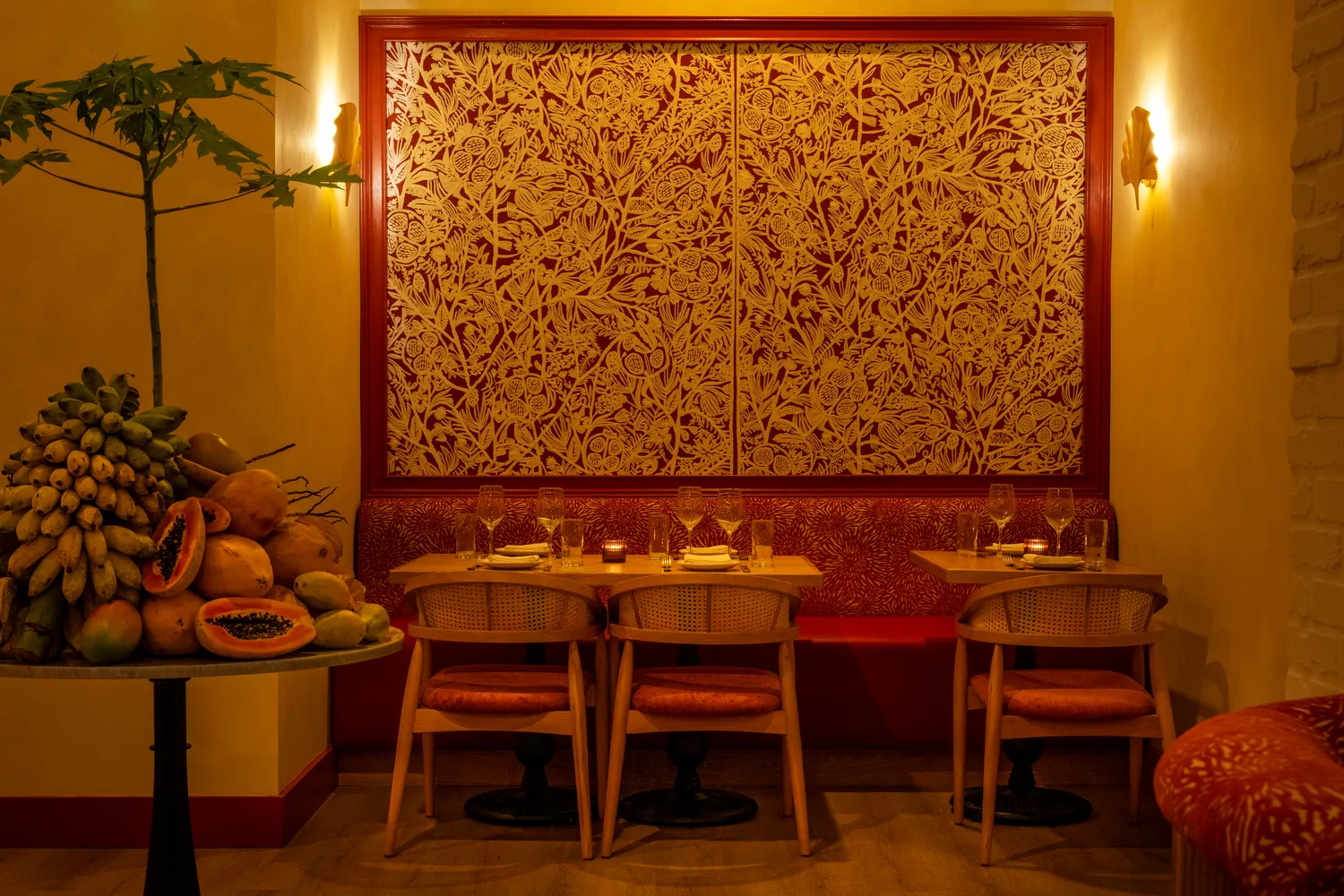 Teal wood bar and woven rattan pendants at Paya, Caribbean-inspired Miami Beach restaurant design