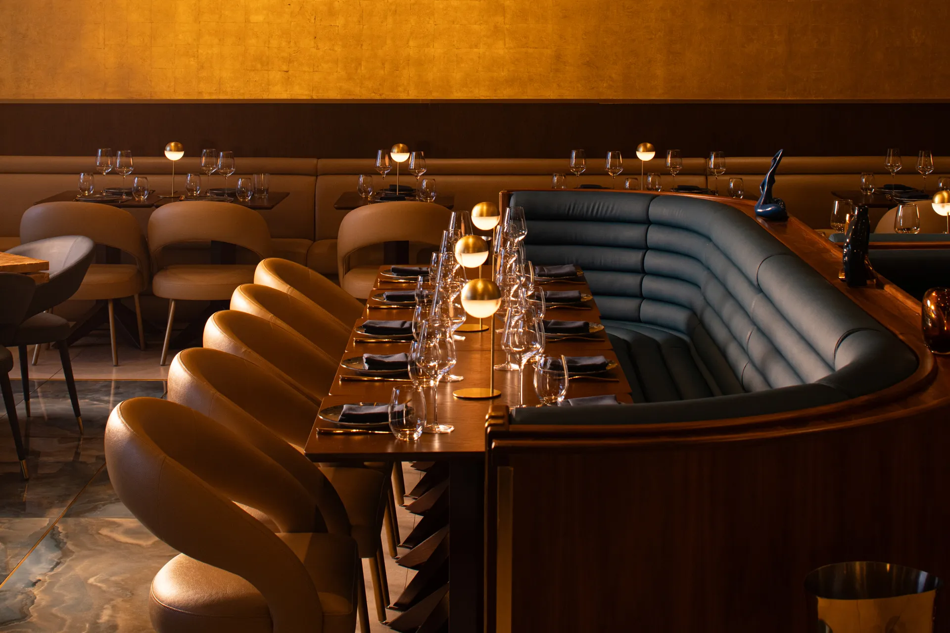 Oro steakhouse dining room with brass fixtures and sculptural chandeliers, Lincoln Road Miami Beach