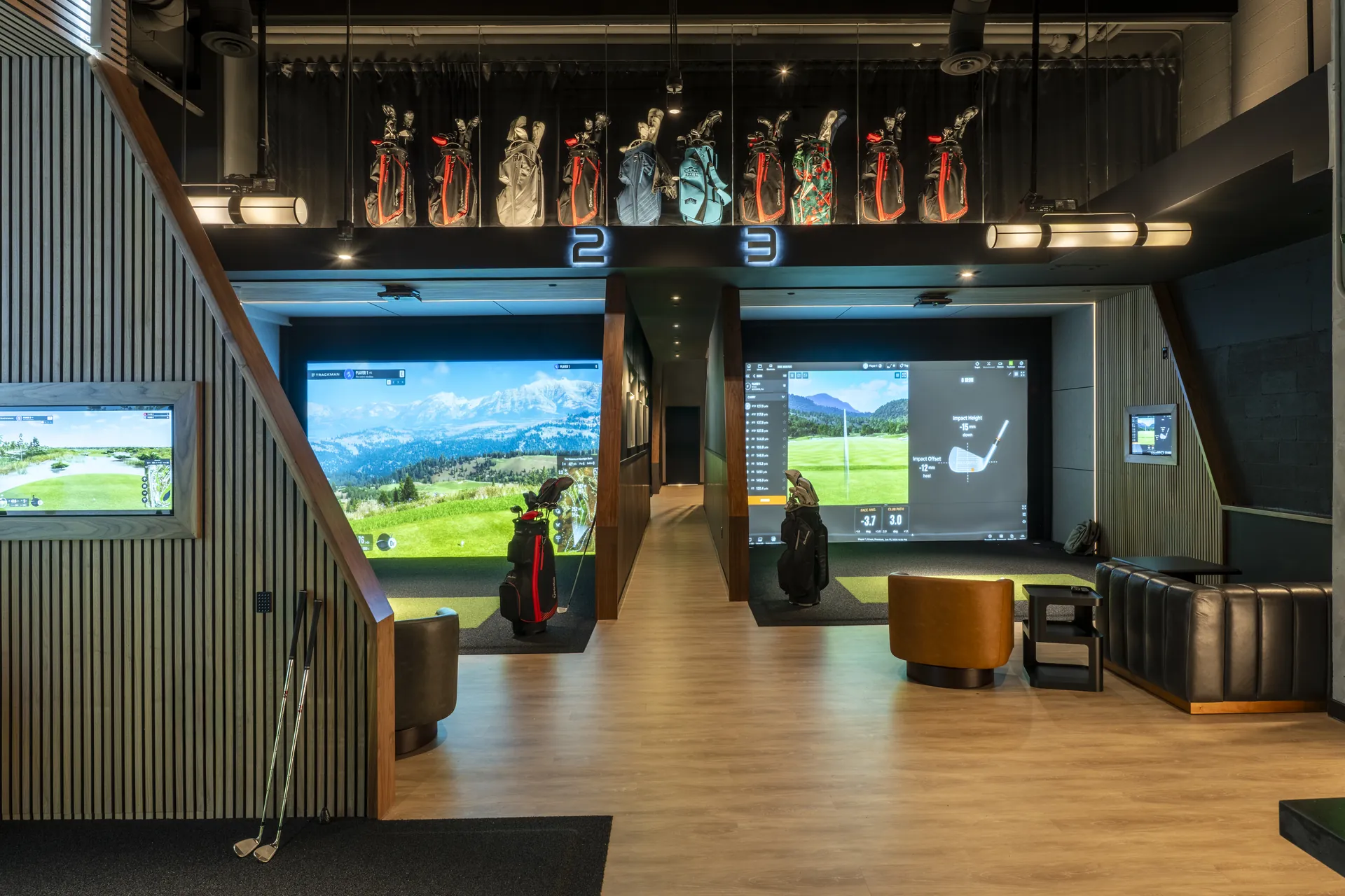 Full simulator bay view with ambient lighting at The Tips Golf, AC Hotel Miami Brickell